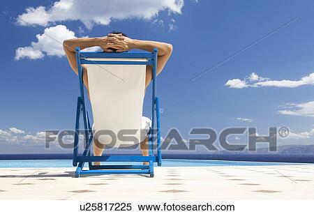 A man relaxing in a deck chair View Large Photo Image Stock Photography - A man relaxing in a deck chair. Fotosearch