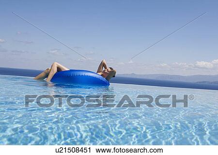 A woman relaxing in a pool View Large Photo Image Stock Image - A woman relaxing in a pool. Fotosearch