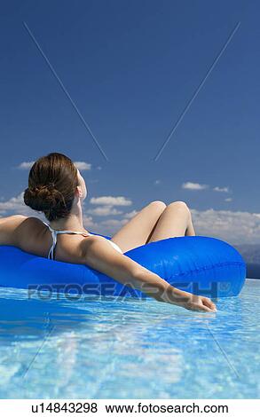 A woman relaxing in a pool View Large Photo Image Stock Photo - A woman relaxing in a pool. Fotosearch