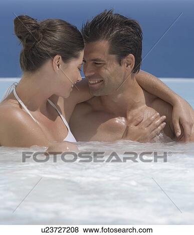 A couple relaxing in a jacuzzi View Large Photo Image Stock Photo - A couple relaxing in a jacuzzi. Fotosearch