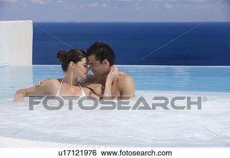 A couple relaxing in a jacuzzi View Large Photo Image Stock Photograph - A couple relaxing in a jacuzzi. Fotosearch