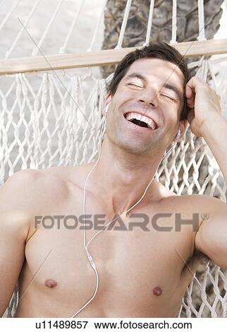 A man relaxing in a hammock View Large Photo Image Stock Photo - A man relaxing in a hammock. Fotosearch