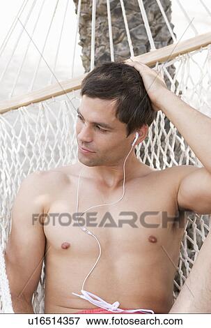 A man relaxing in a hammock View Large Photo Image Stock Photo - A man relaxing in a hammock. Fotosearch
