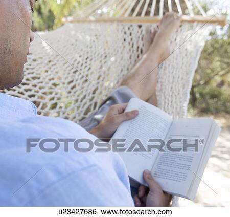Stock Photograph - A man relaxing in a hammock. Fotosearch