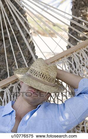 Stock Photography - A man relaxing in a hammock. Fotosearch