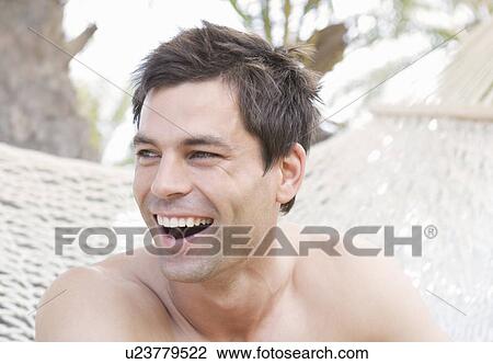 A man sitting in a hammock View Large Photo Image Stock Image - A man sitting in a hammock. Fotosearch