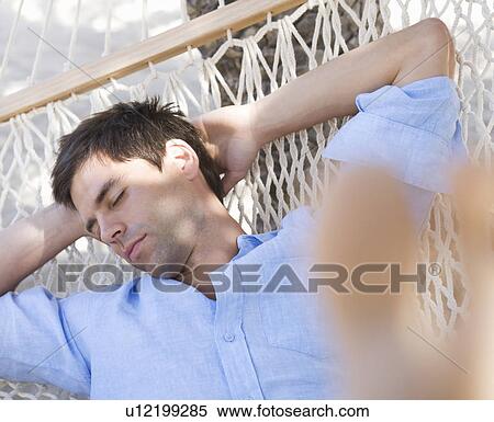 A man sleeping in a hammock View Large Photo Image Stock Photography - A man sleeping in a hammock. Fotosearch