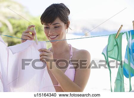 Stock Image - A woman hanging washing out to dry. Fotosearch