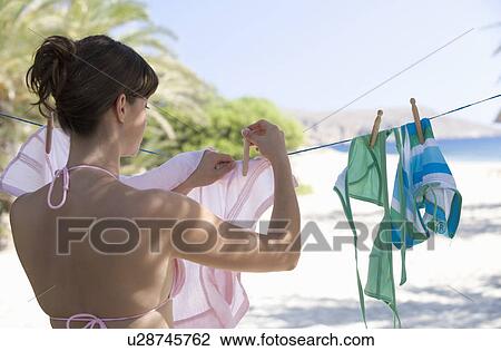 Stock Image - A woman hanging washing out to dry. Fotosearch