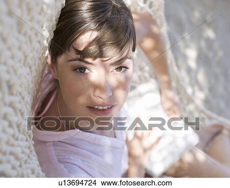 Picture - A woman relaxing in a hammock. Fotosearch