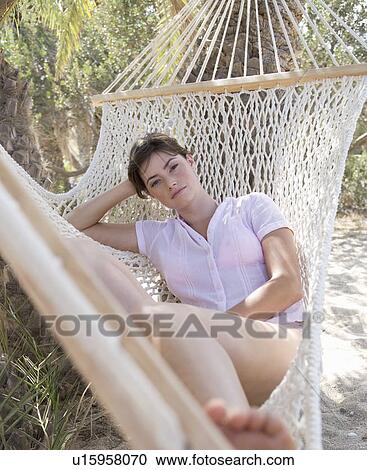 A woman relaxing in a hammock View Large Photo Image Stock Image - A woman relaxing in a hammock. Fotosearch