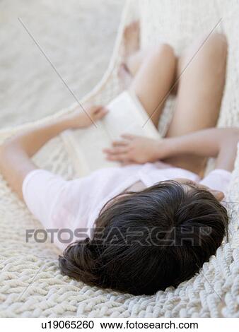 A woman relaxing in a hammock View Large Photo Image Stock Image - A woman relaxing in a hammock. Fotosearch