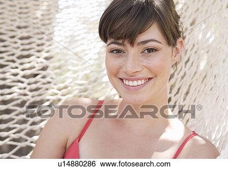 A woman relaxing in a hammock View Large Photo Image Stock Photograph - A woman relaxing in a hammock. Fotosearch