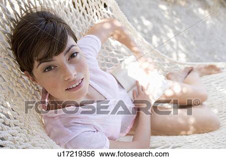 A woman relaxing in a hammock View Large Photo Image Stock Photograph - A woman relaxing in a hammock. Fotosearch