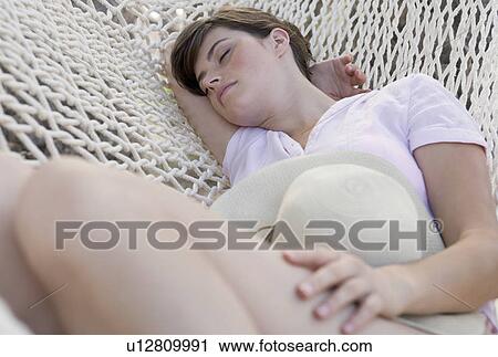 A woman sleeping in a hammock View Large Photo Image Stock Image - A woman sleeping in a hammock. Fotosearch