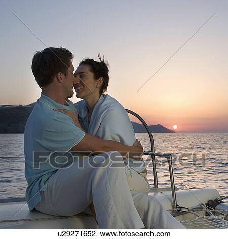 Stock Image - A couple kissing on a boat. Fotosearch