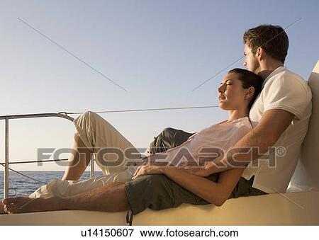 Stock Photo - A couple relaxing on a boat. Fotosearch