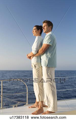 Stock Photo - A couple relaxing on a boat. Fotosearch