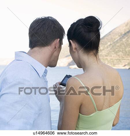 Stock Photograph - A couple taking holiday photos. Fotosearch