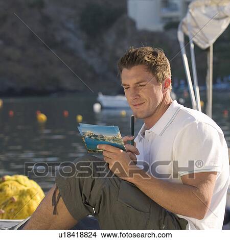 A man writing a postcard View Large Photo Image Picture - A man writing a postcard. Fotosearch
