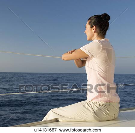 A woman relaxing on a boat View Large Photo Image Stock Photo - A woman relaxing on a boat. Fotosearch