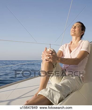 A woman relaxing on a boat View Large Photo Image Stock Photo - A woman relaxing on a boat. Fotosearch