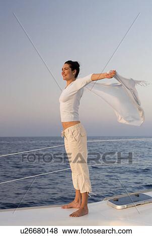 Stock Photo - A woman relaxing on a boat. Fotosearch