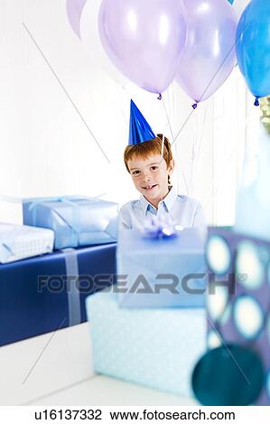 boy at birthday party surrounded by presents View Large Photo Image Stock Image - boy at birthday party surrounded by presents. Fotosearch
