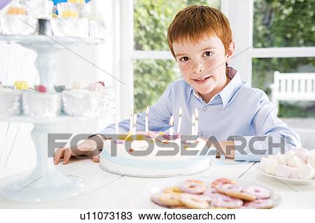 boy sitting at birthday tea table View Large Photo Image Stock Image - boy sitting at birthday tea table. Fotosearch
