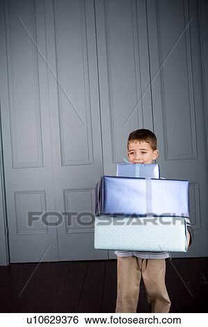little boy carrying presents View Large Photo Image Stock Photograph - little boy carrying presents. Fotosearch