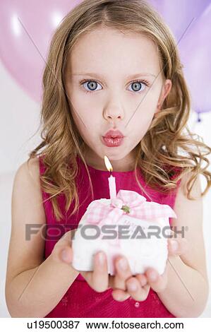 little girl blowing out candle on miniature birthday cake View Large Photo Image Stock Photo - little girl blowing out candle on miniature birthday cake. Fotosearch