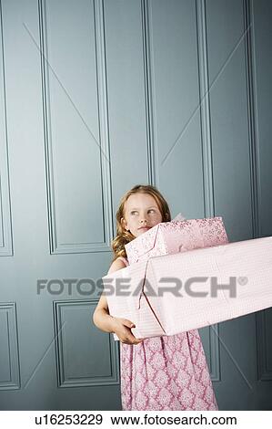little girl carrying presents View Large Photo Image Stock Photo - little girl carrying presents. Fotosearch