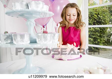 little girl looking down at birthday cake View Large Photo Image Stock Photo - little girl looking down at birthday cake. Fotosearch