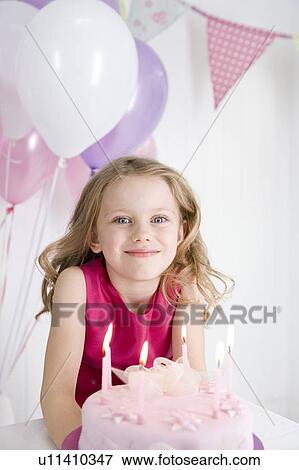 little girl sitting at table with birthday cake View Large Photo Image Stock Photo - little girl sitting at table with birthday cake. Fotosearch