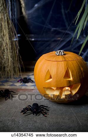 Atmospheric Hallowe'en scene - pumpkin, broomstick and spiders View Large Photo Image Stock Photography - Atmospheric Hallowe'en scene - pumpkin, broomstick and spiders . Fotosearch