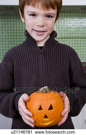 Boy holding a Jack'o Lantern for Halloween View Large Photo Image Stock Image - Boy holding a Jack'o Lantern for Halloween . Fotosearch