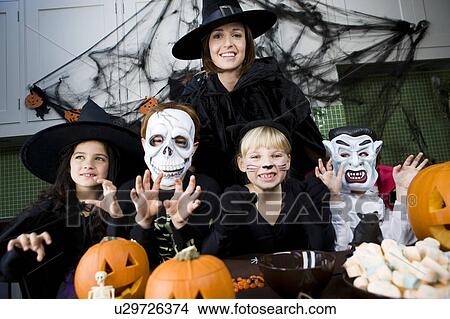 Four friends and a mother at a Halloween party View Large Photo Image Picture - Four friends and a mother at a Halloween party . Fotosearch