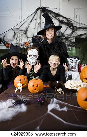 Four friends and a mother at a Halloween party View Large Photo Image Stock Photography - Four friends and a mother at a Halloween party . Fotosearch