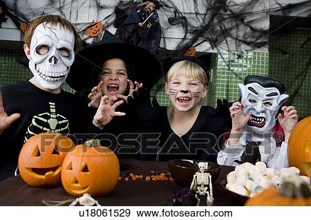 Four friends at a Halloween party View Large Photo Image Stock Photo - Four friends at a Halloween party . Fotosearch