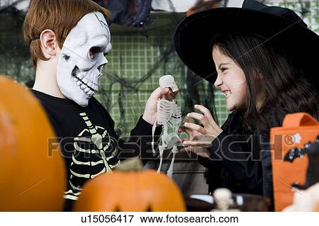 Little boy and girl at a Halloween party View Large Photo Image Stock Photo - Little boy and girl at a Halloween party . Fotosearch