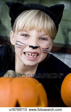 Little girl in a cat outfit dressed up for Halloween View Large Photo Image Stock Image - Little girl in a cat outfit dressed up for Halloween . Fotosearch
