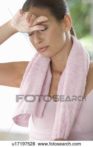 Stock Photo - A woman standing in a gym. Fotosearch