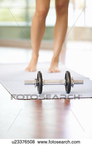 Stock Photo - A woman standing in a gym. Fotosearch