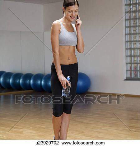 Stock Image - A young woman at a gym. Fotosearch