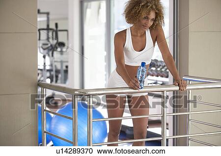 A young woman standing in a gym View Large Photo Image Stock Image - A young woman standing in a gym. Fotosearch