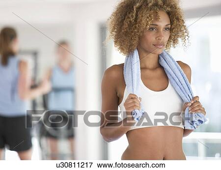 A young woman standing in a gym View Large Photo Image Stock Photo - A young woman standing in a gym. Fotosearch