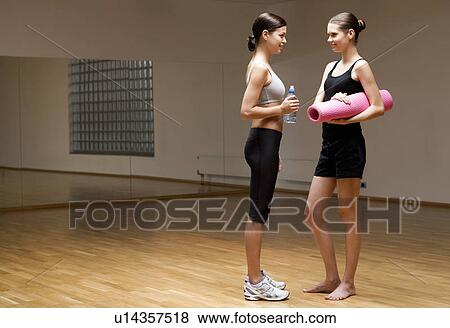 Two young women in a gym View Large Photo Image Stock Photo - Two young women in a gym. Fotosearch