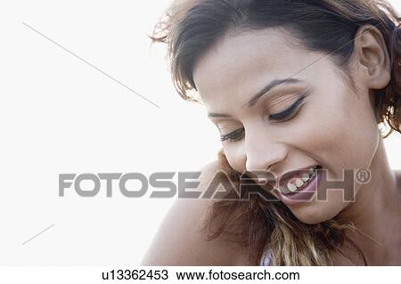 Close-up of a young woman smiling View Large Photo Image Stock Image - Close-up of a young woman smiling. Fotosearch