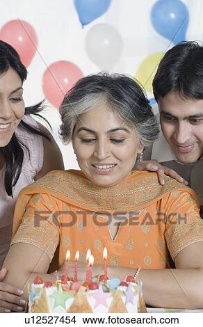Mature woman celebrating her birthday with her children View Large Photo Image Picture - Mature woman celebrating her birthday with her children. Fotosearch