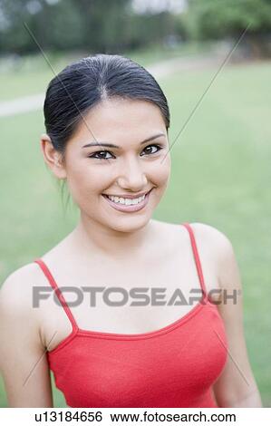 Portrait of a young woman smiling View Large Photo Image Stock Photograph - Portrait of a young woman smiling. Fotosearch